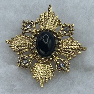 Vintage black cabochon Maltese Cross or starbust ornate scrollwork.